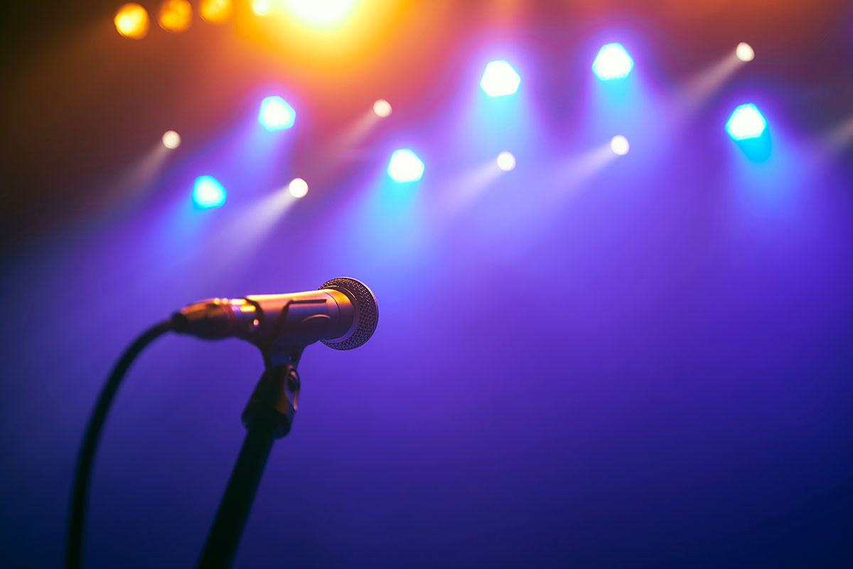 microphone on stage facing spotlights